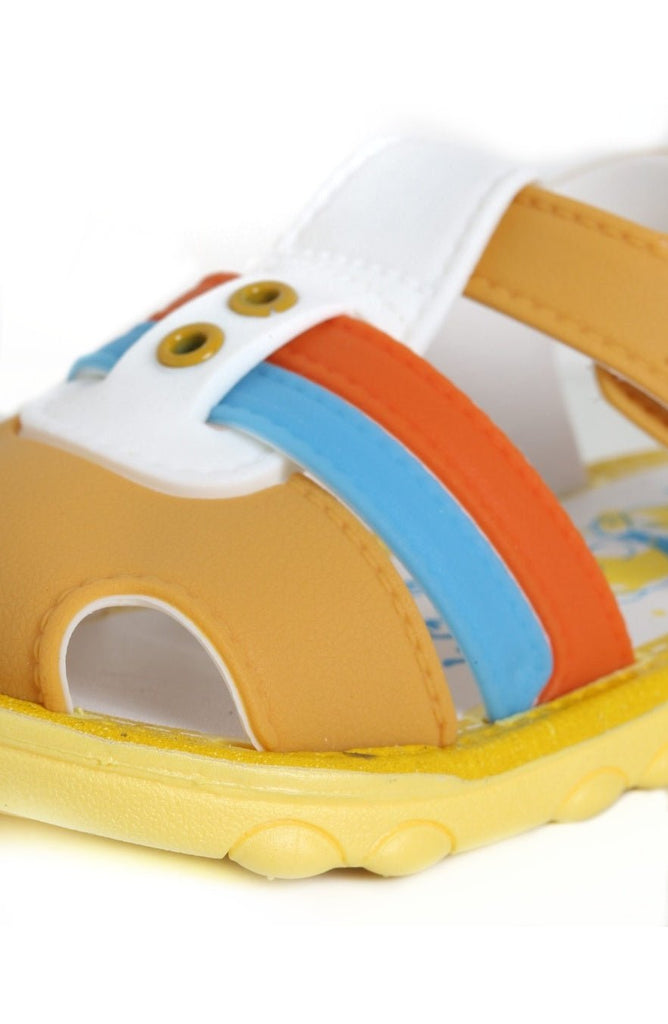 Close-up of the secure velcro strap on brown comfort sandals with playful stripe design