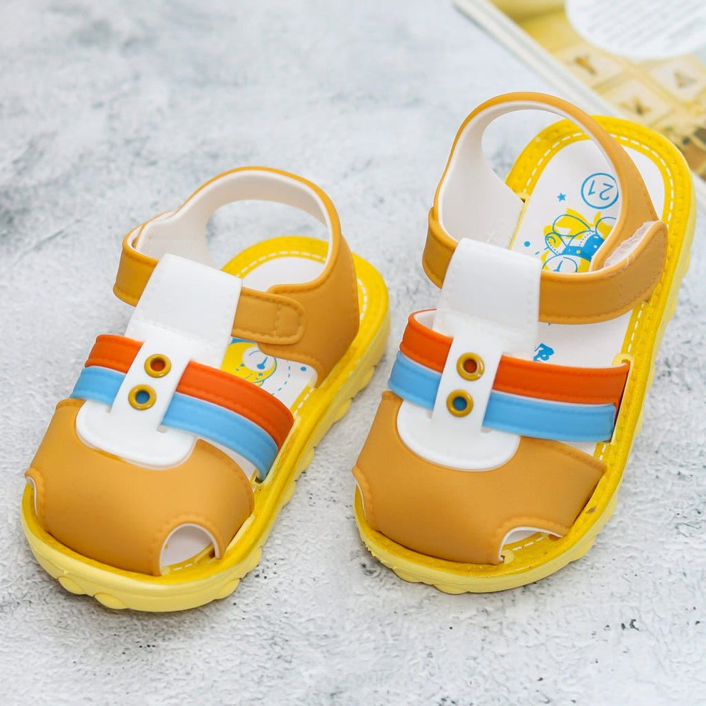 Playful brown comfort sandals with colorful stripes and a cute cartoon insole for kids