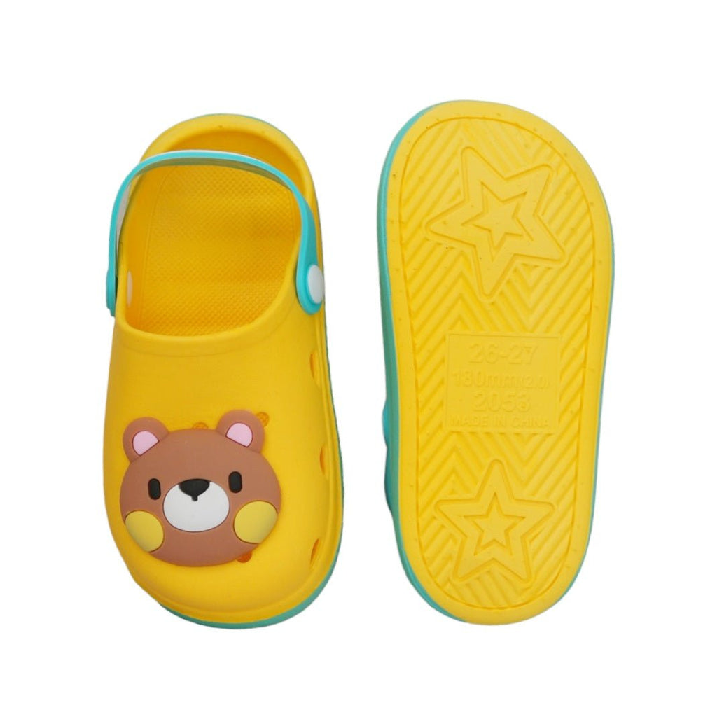 Underneath view of kids' yellow clog showcasing the star-patterned non-slip sole.