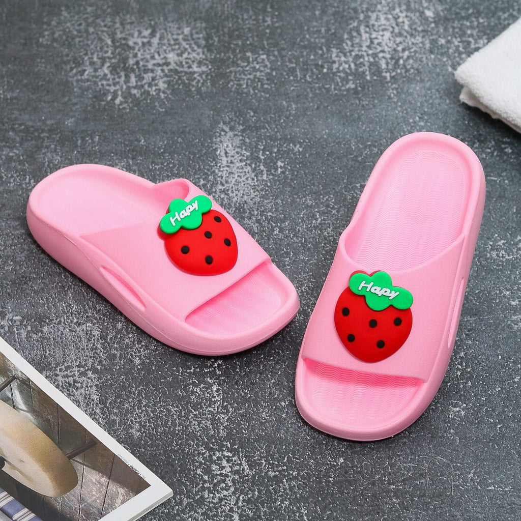 Child's pink slide with a cheerful red strawberry applique on top view