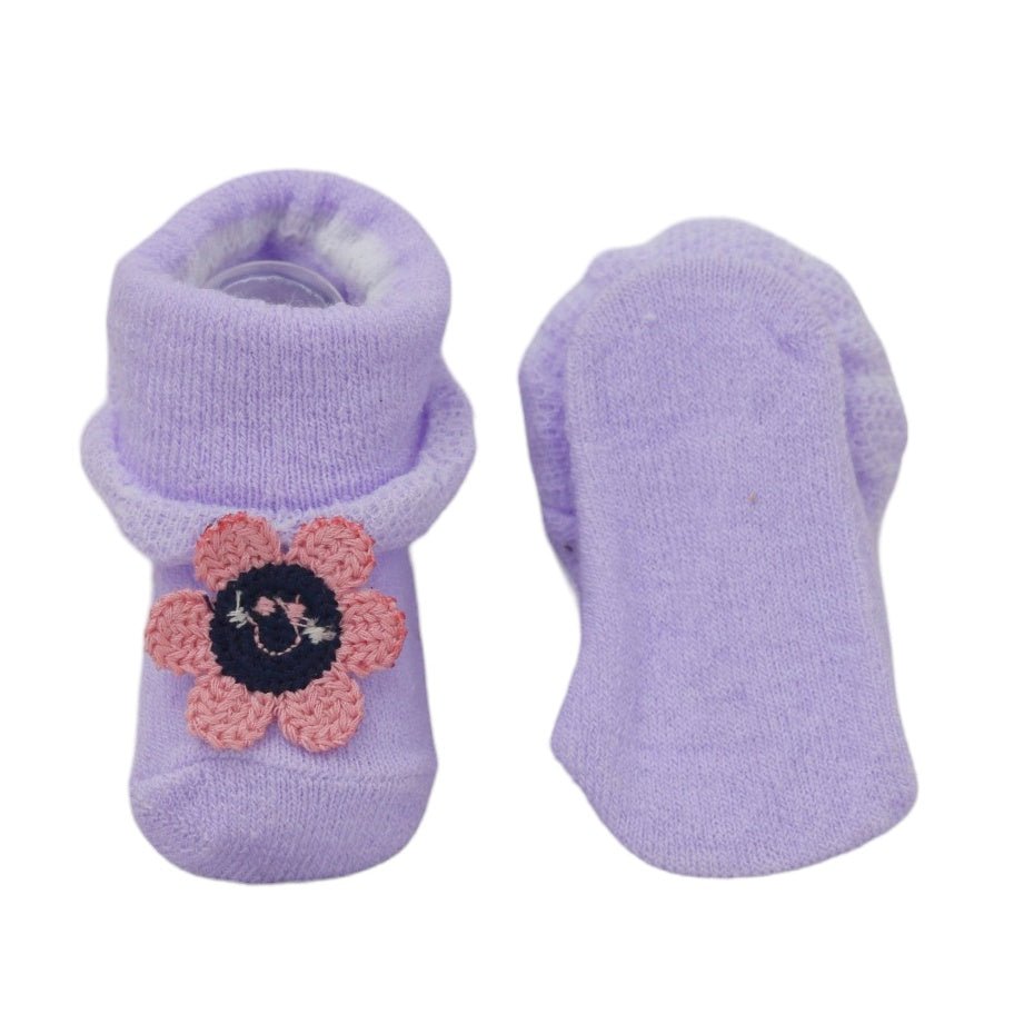 Lavender baby socks with crochet flower applique, showing top and bottom views.