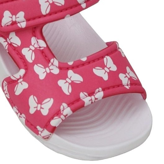 Close-up of kid's pink sandal with white bow print
