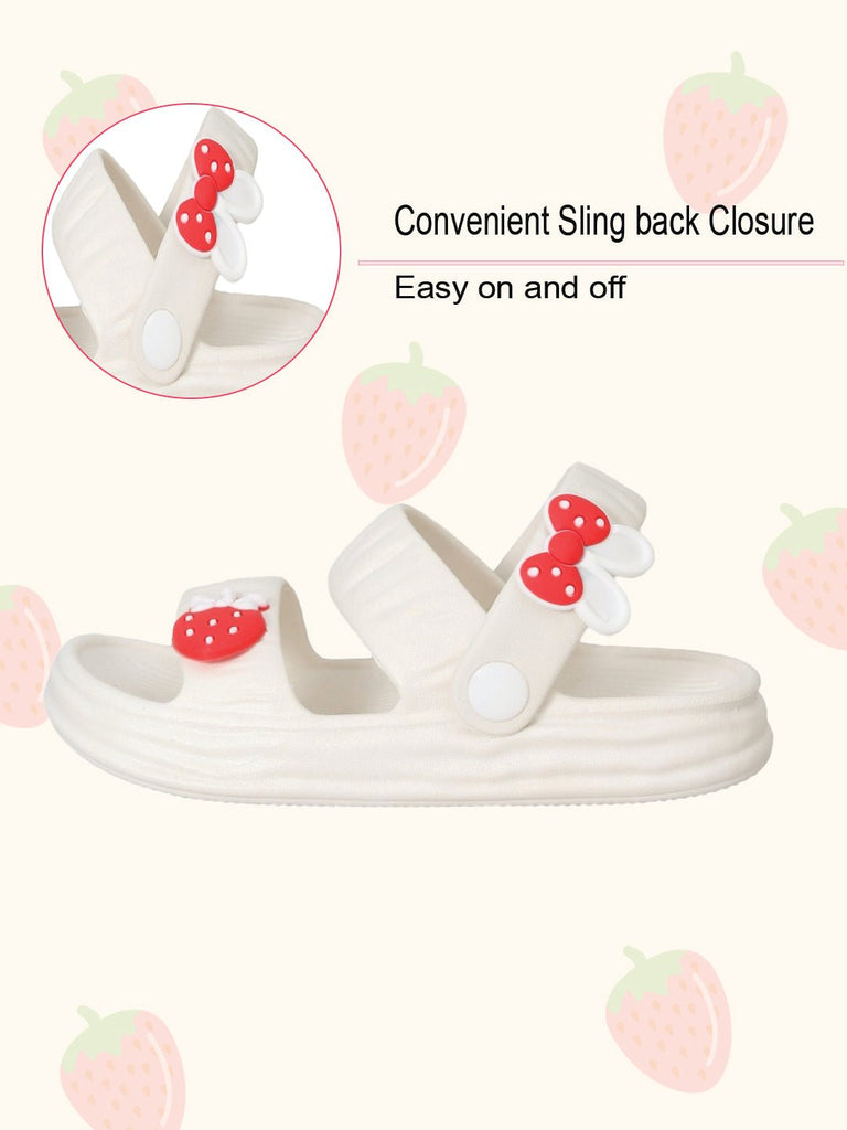Side view of white sandals with strawberry and bow, showing the slingback strap for easy wear