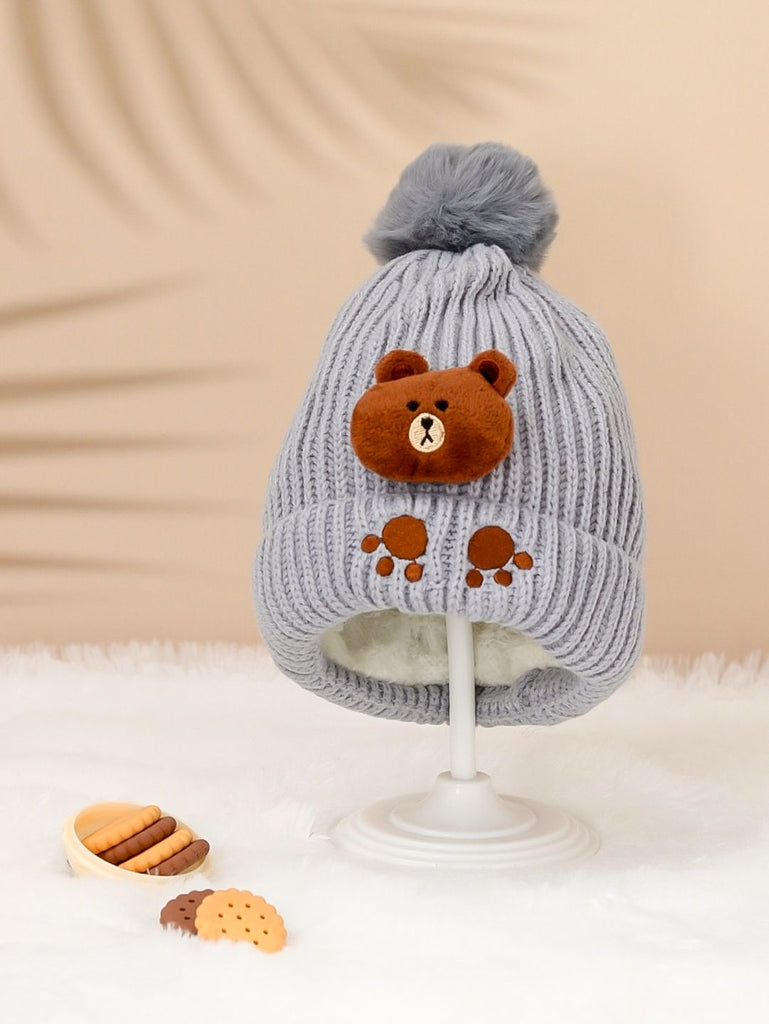 Cozy grey knit hat with a teddy applique and fluffy pom-pom for boys.