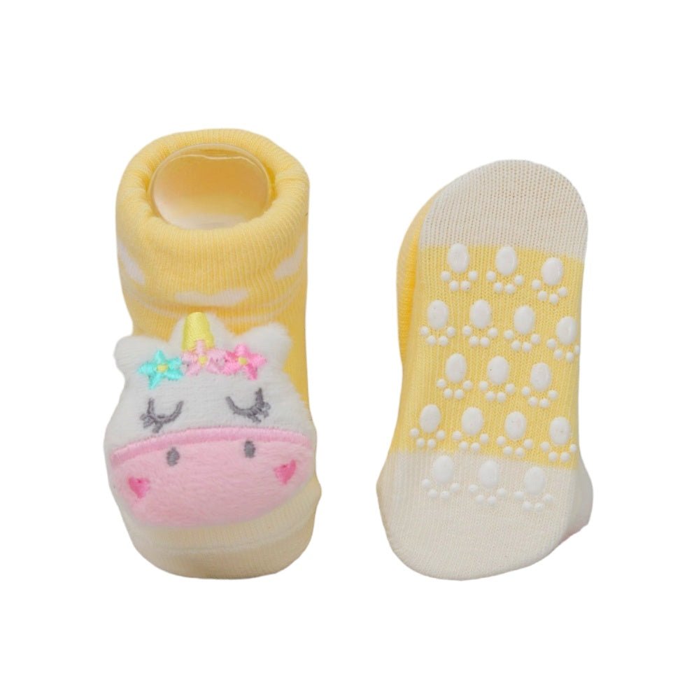 Anti-slip sole of baby girl's pink teddy bear sock showcasing safety features.