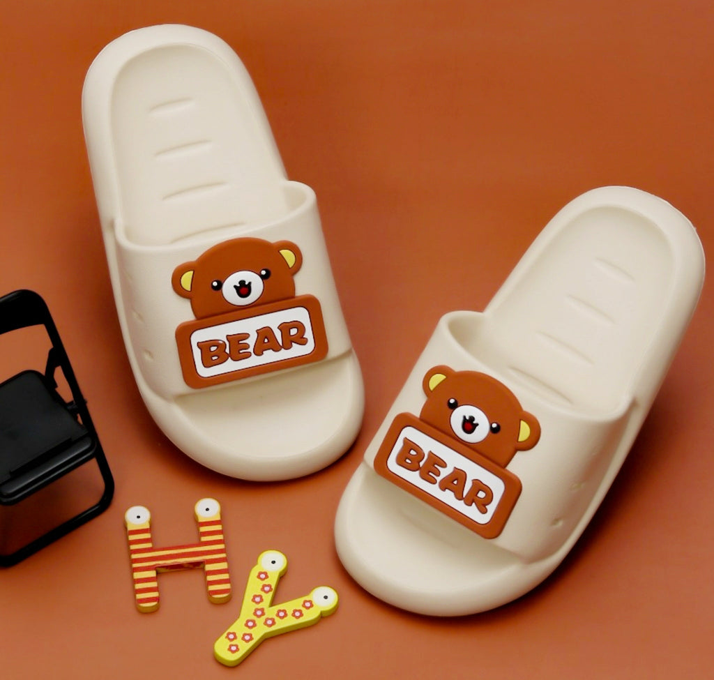 Kids' Teddy Bear Applique Slides by Yellow Bee on warm orange background