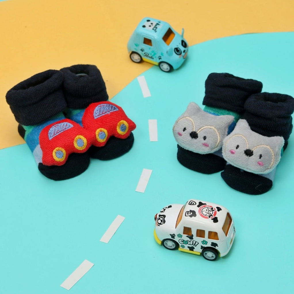 Baby boy's cat and car socks set on a playful background with toy vehicles