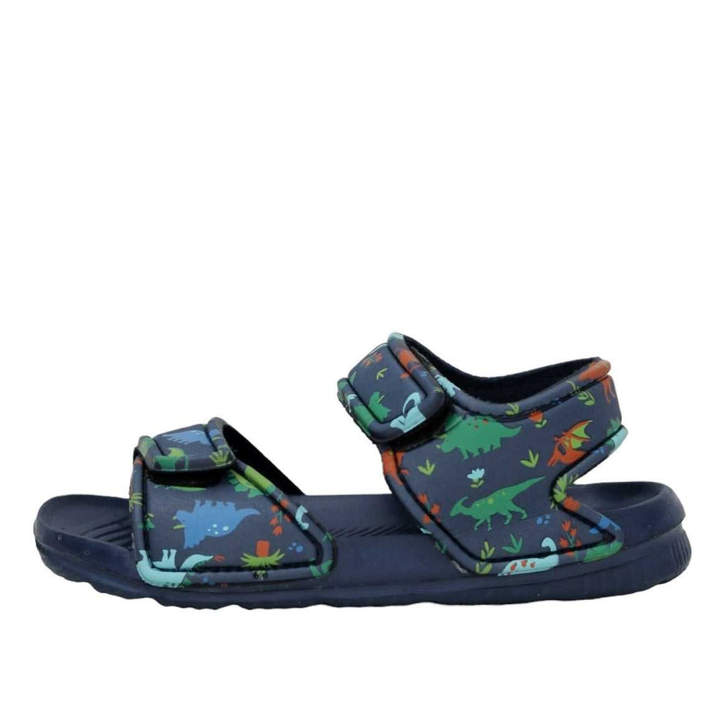 "Lateral view of navy sandals featuring a playful all-over dino print, ideal for adventurous little ones