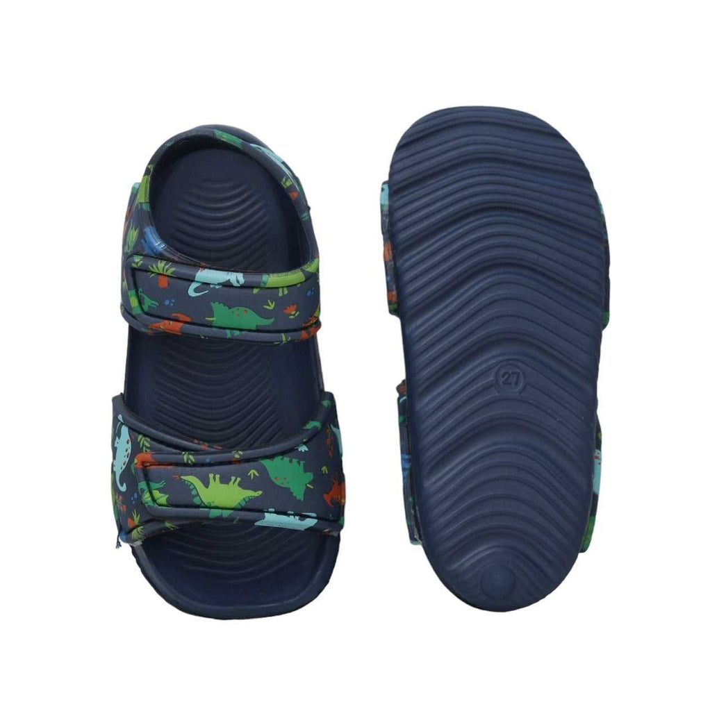 Top and sole view of navy kids' sandals adorned with a lively dinosaur print, designed for play and comfort.