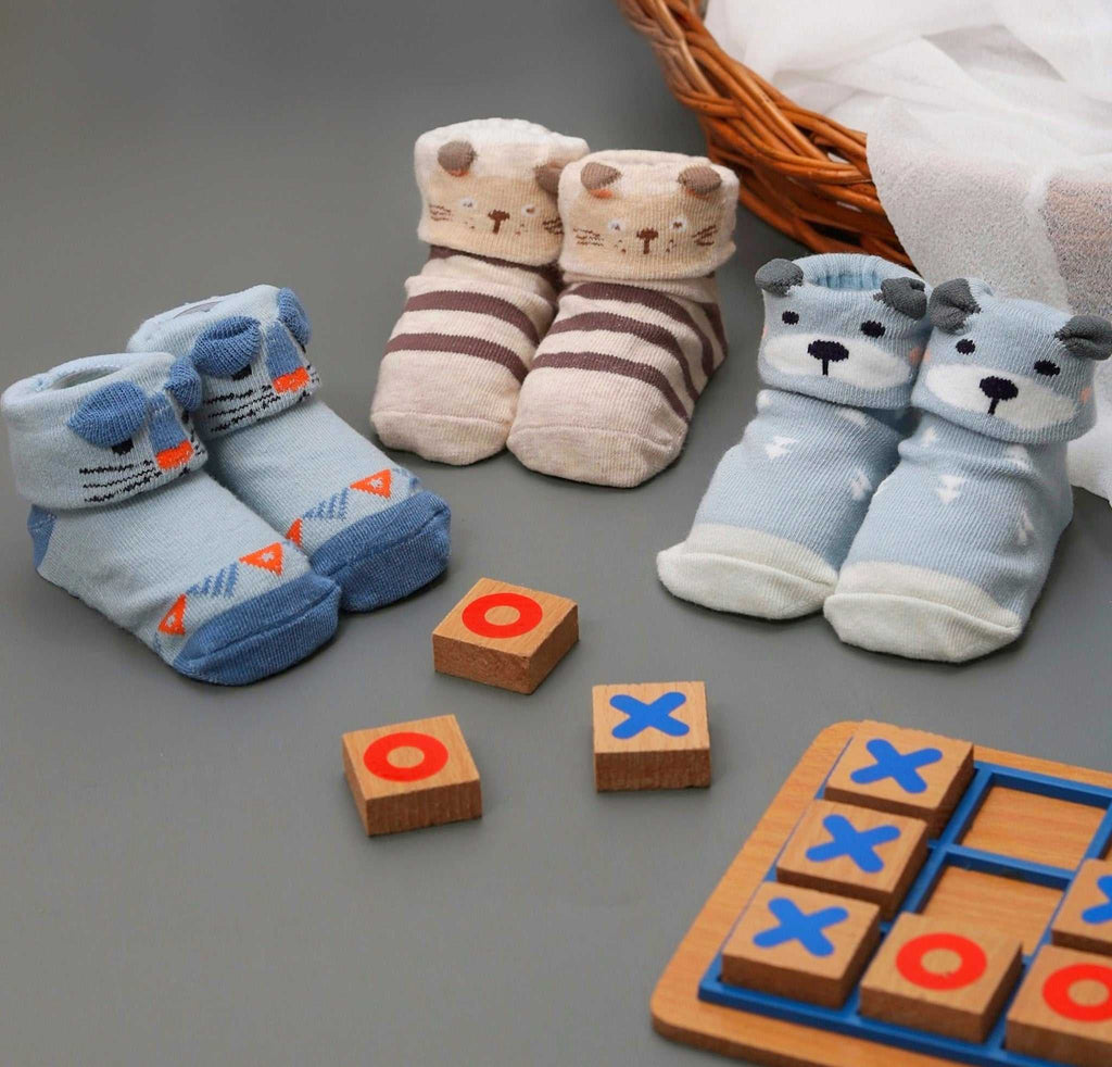 Assortment of animal-themed anti-skid socks for baby boys on a playful background.