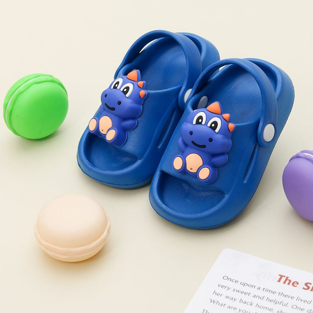 Overhead view of blue dino sandals with playful toys.