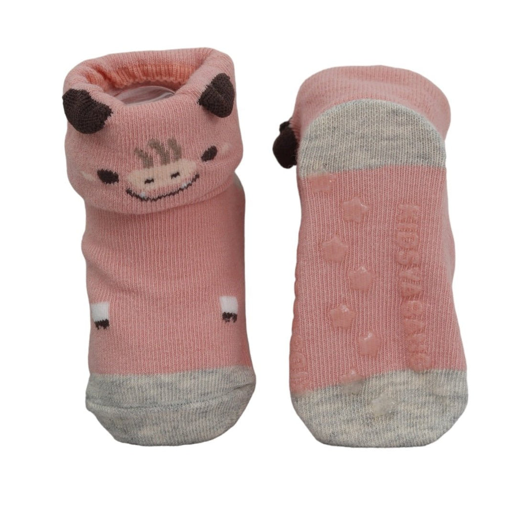 Anti-skid soles of pink cow-themed socks for baby girls, highlighting the safety treads.