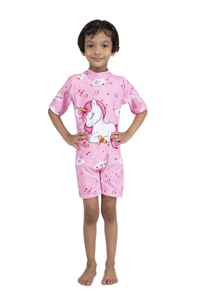 Young girl smiling in her Pink Unicorn Half Sleeves Swimsuit by Yellow Bee, ready for pool time