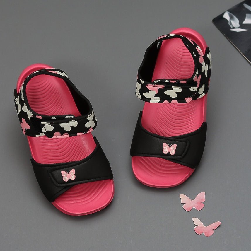 Kids' Pink Butterfly Print Sandals with secure black straps on a gray background
