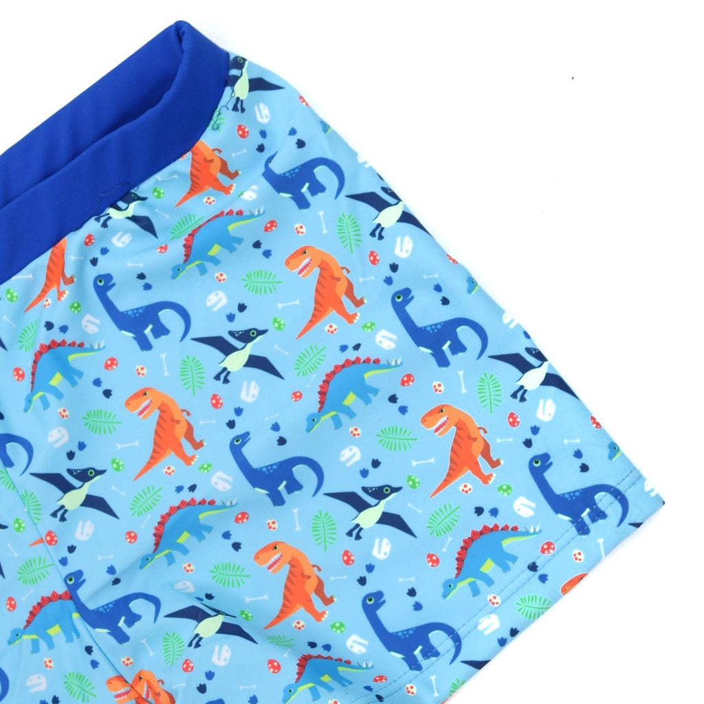 Close-up of the playful dinosaur print on Yellow Bee's Swim Trunks, perfect for young boys' summer adventures.