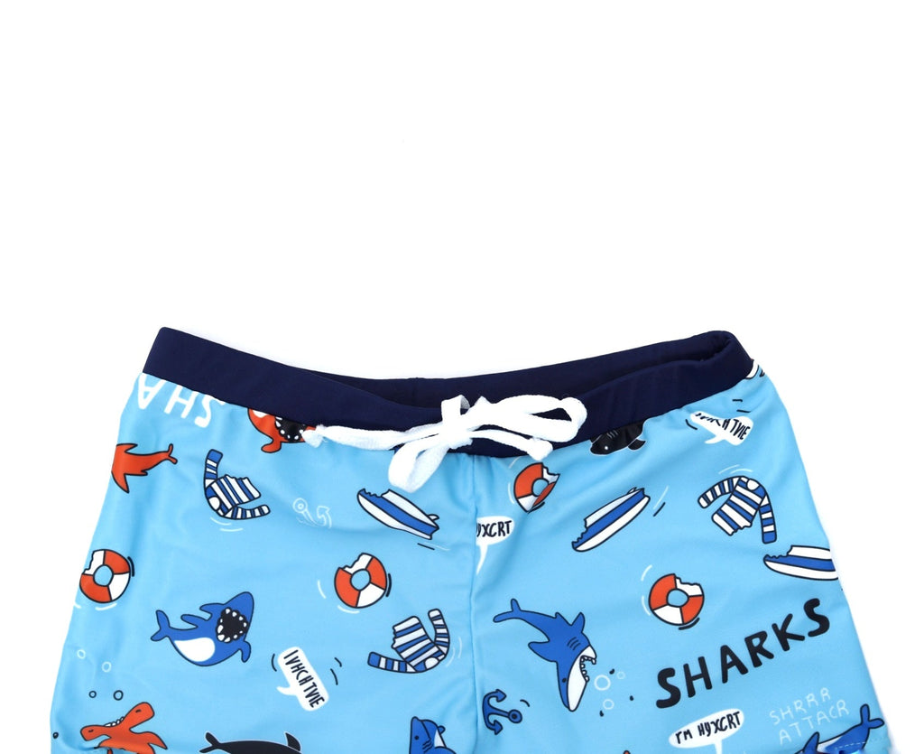 Dynamic Blue Swim Trunks with Shark Patterns laid out, ready for poolside action.
