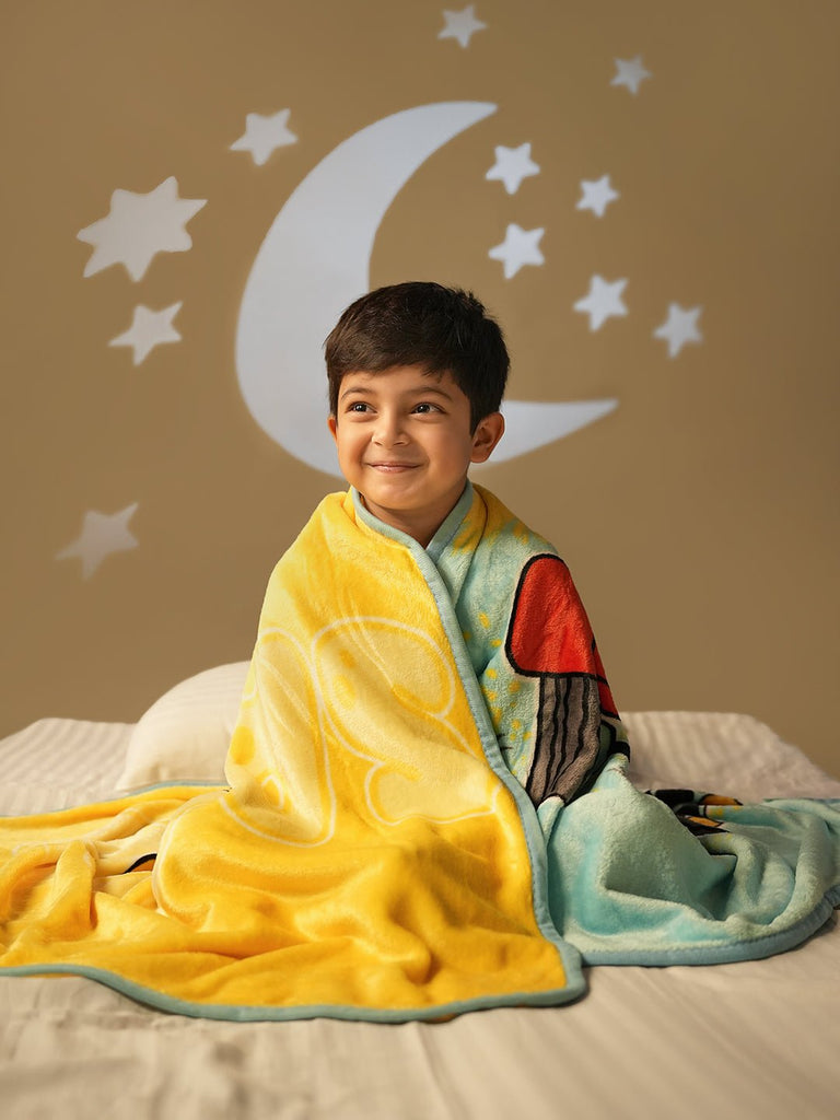 Happy Child Sitting in Bed with Yellow Giraffe Blanket