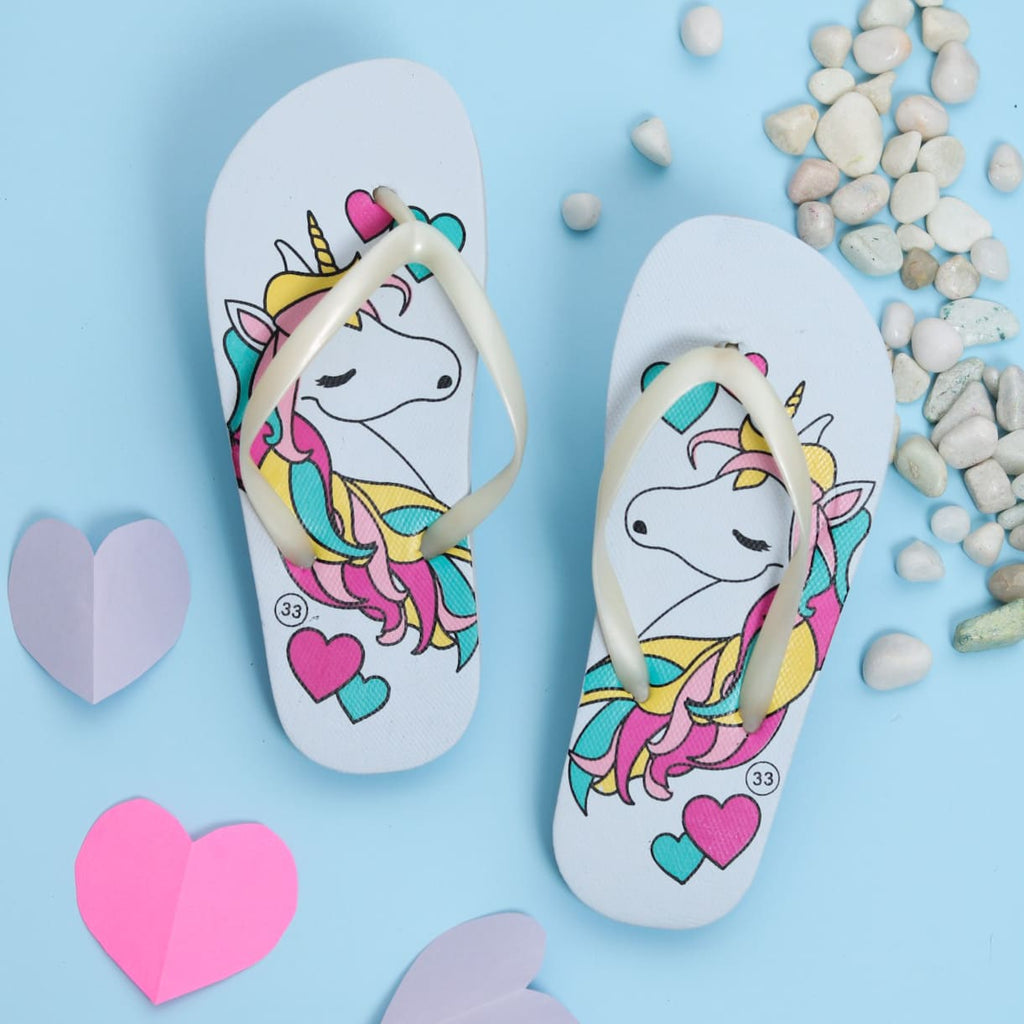 Pair of light blue unicorn flip-flops for girls, perfect for imaginative play.