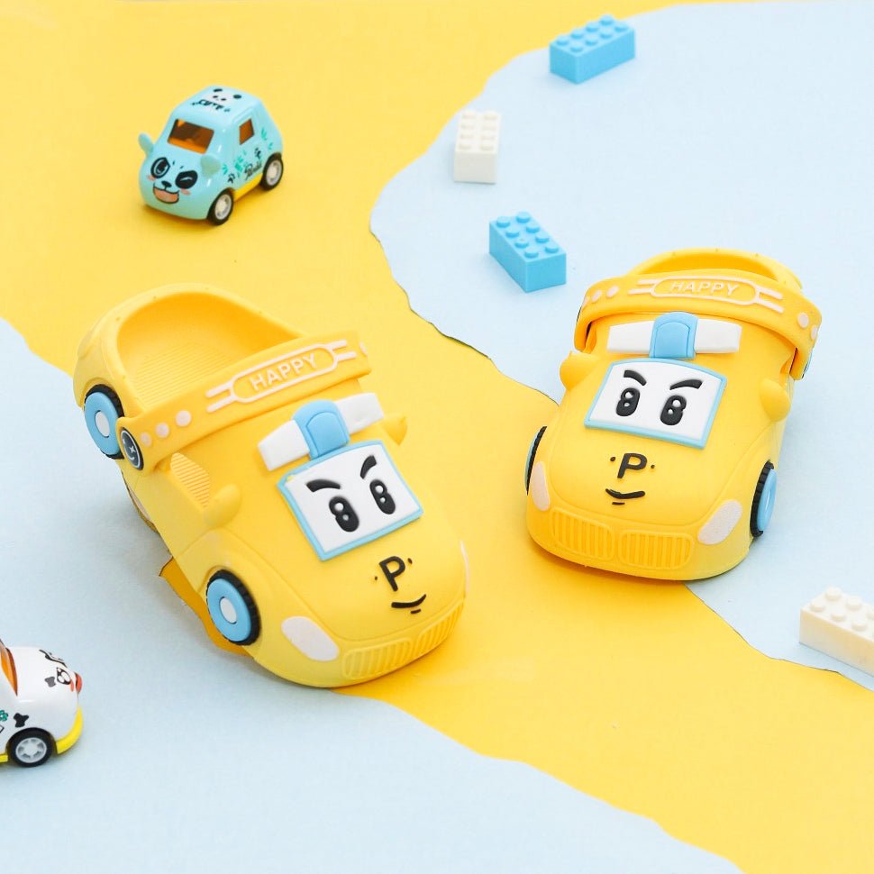 Yellow car pattern clogs for boys by Yellow Bee showcased on a playful background.