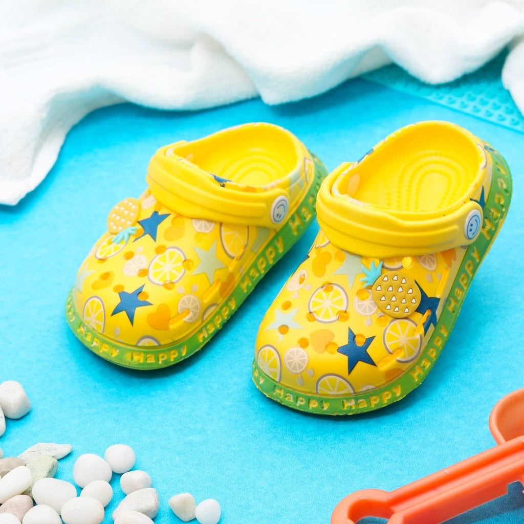 Yellow Kids' Clogs with Citrus Fruit and Star Patterns on a Bright Summer Background