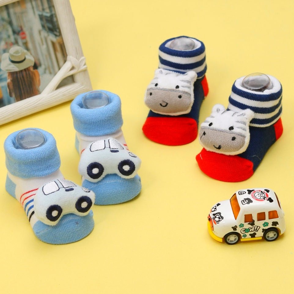 A set of infant socks with zebra and car stuffed toys against a playful background.