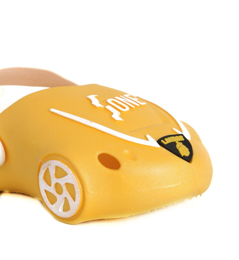 Close-Up of the Front Part of Kid's Yellow Car Clogs Showing the Headlights and Grille